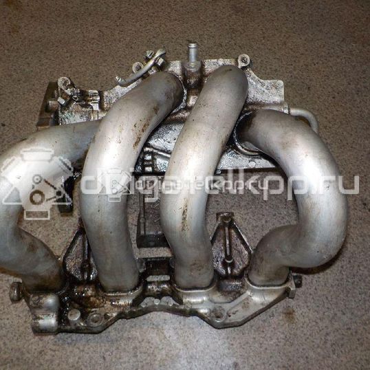 Фото Коллектор впускной для двигателя QG16DE для Nissan Sunny / Bluebird / Avenir / Primera / Almera 102-120 л.с 16V 1.6 л бензин 14010AU300